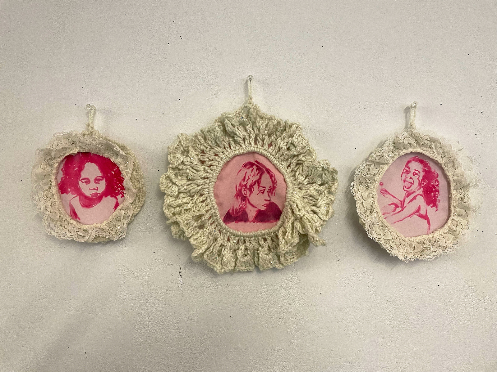 Three self-portraits (ranging in ages) using dispersed dye in a monochrome palette. Each portrait is framed with a crocheted border.