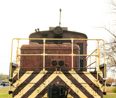 An old locomotive is parked in a field in Cornwall, Ontario waiting for tourists to take its photo.