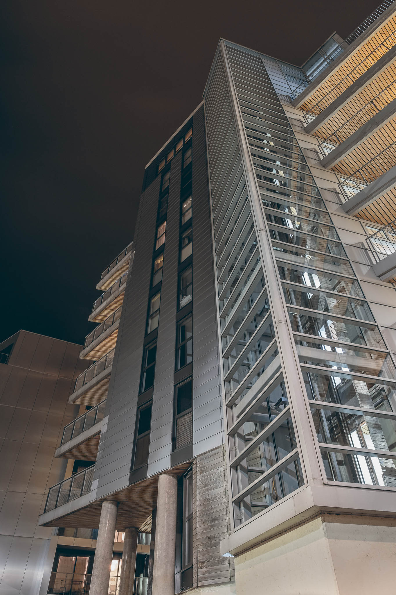 Looking up at apartment blocks with a wide angle lens at night with the lighting from the buildings illuminating the images
