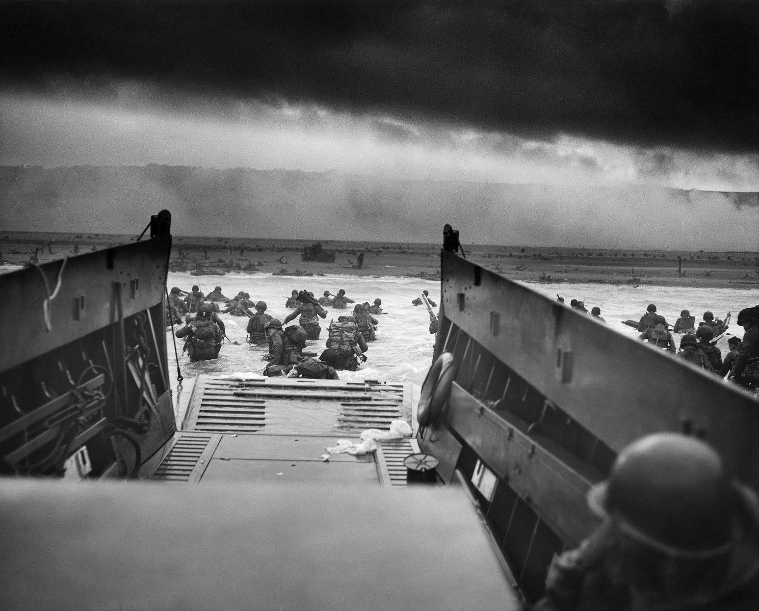 Taxis to Hell and Back – Into the Jaws of Death and was taken at around 7.40 am on 6 June 1944 by Coastguard Chief Photographers Mate Robert F Sargent as the D Day invasion begun.