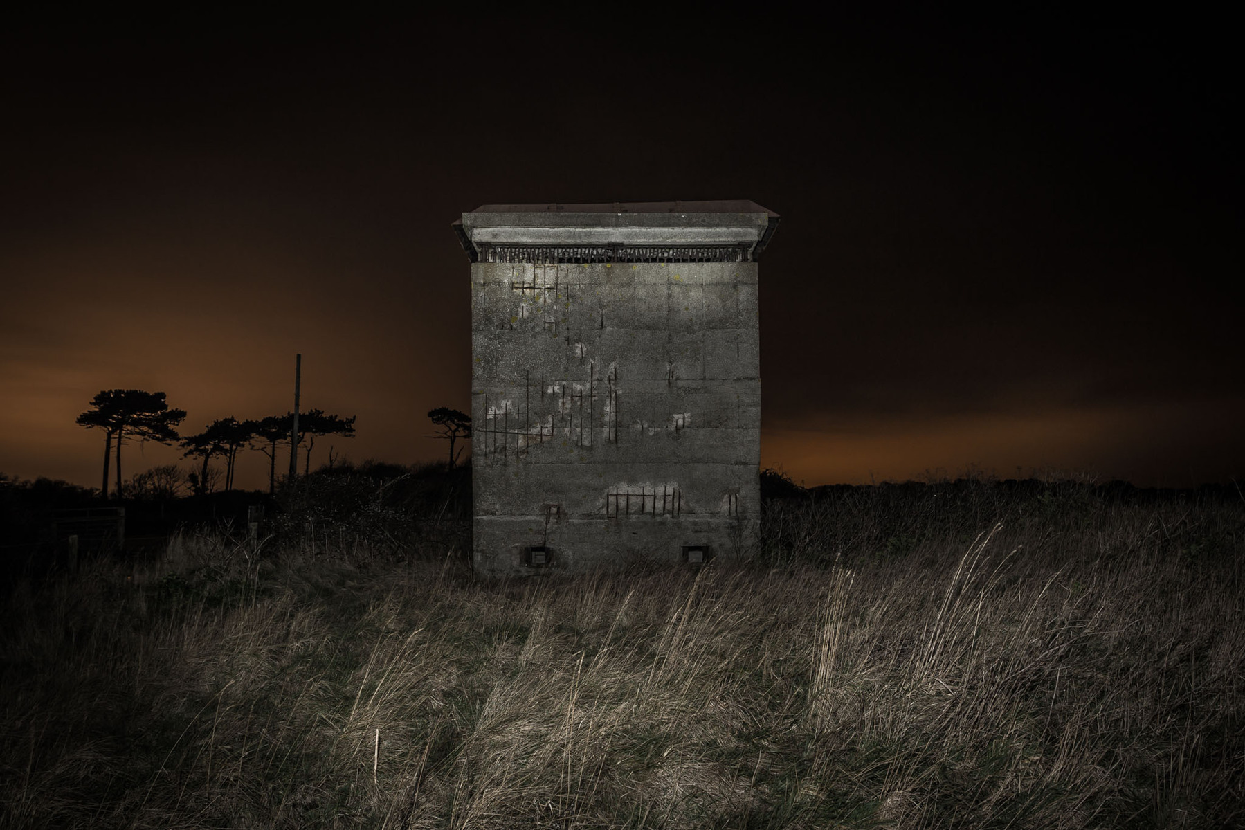 WW2 lookout tower BUNKER at night illuminated with flash lighting.