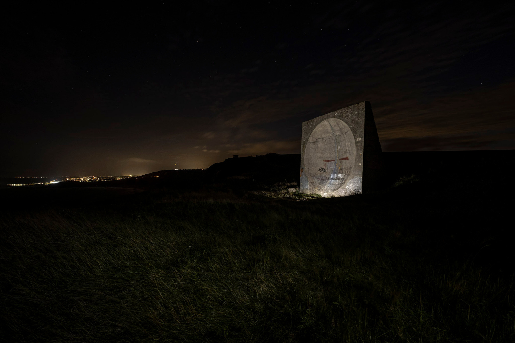 Early radar dishes called a Sound mirror on the white cliffs of Dover photographed at night.