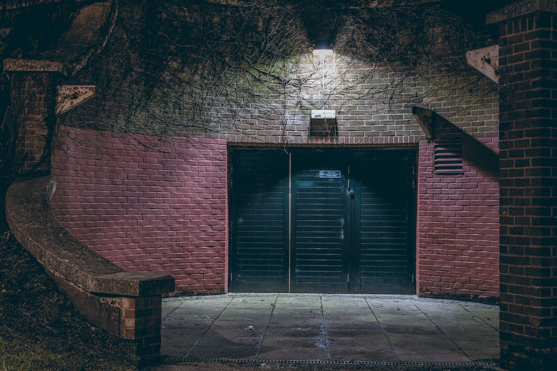 A fire exit door for the castle mall in Norwich Norfolk with flood lighting falling down adding security to it