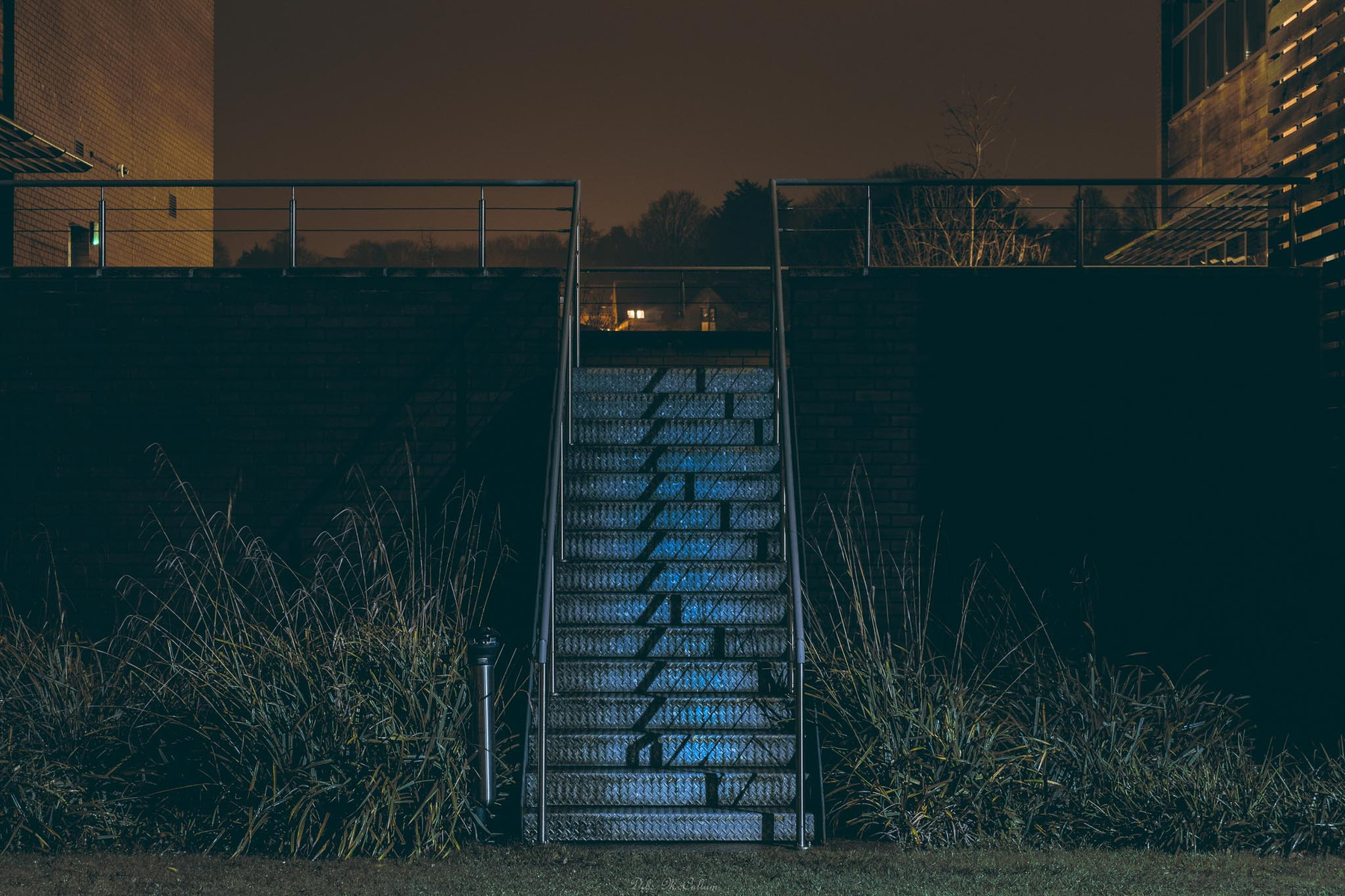 Metal steps sited between 2 office blocks illuminated at night by flood lights in Norwich Norfolk