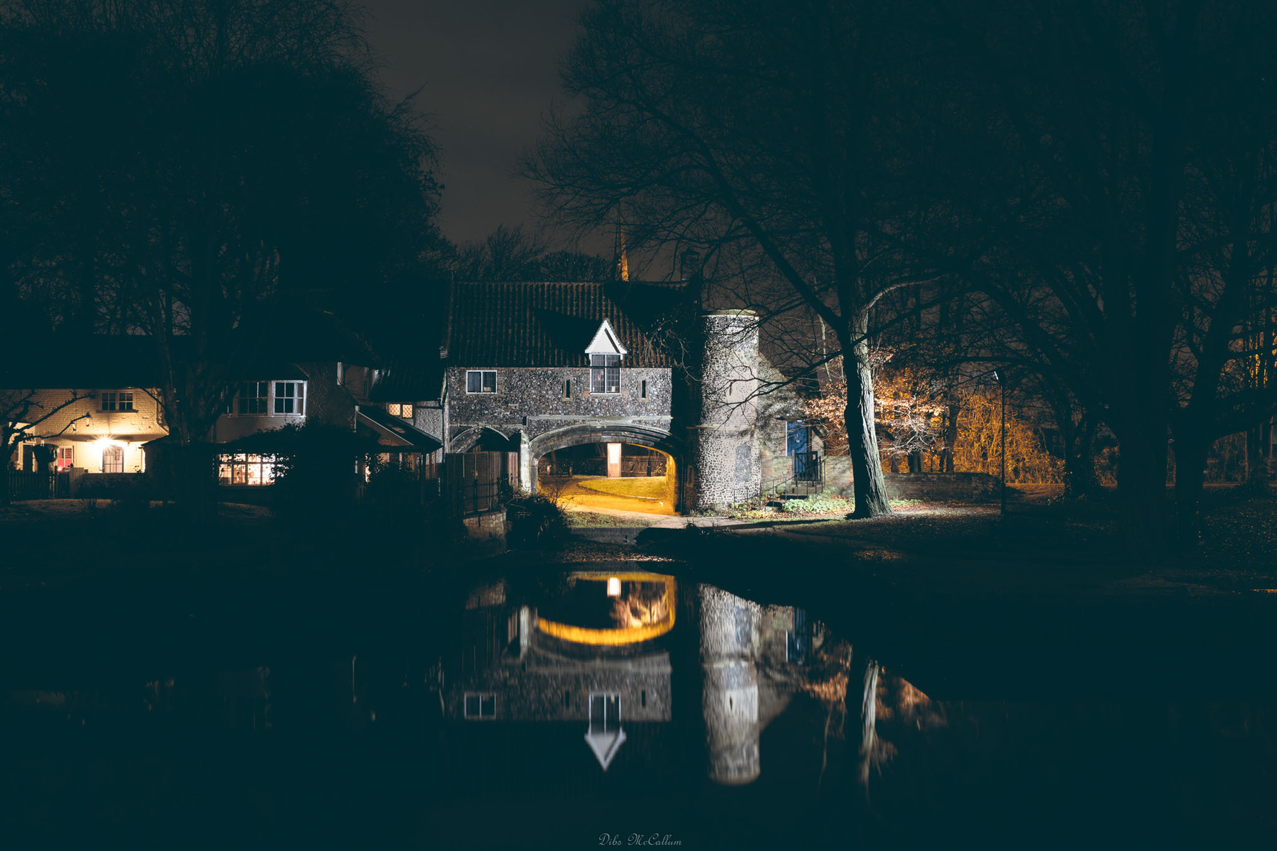 Pulls ferry in Norwich on the River Wensum at night with ambient light illuminating it