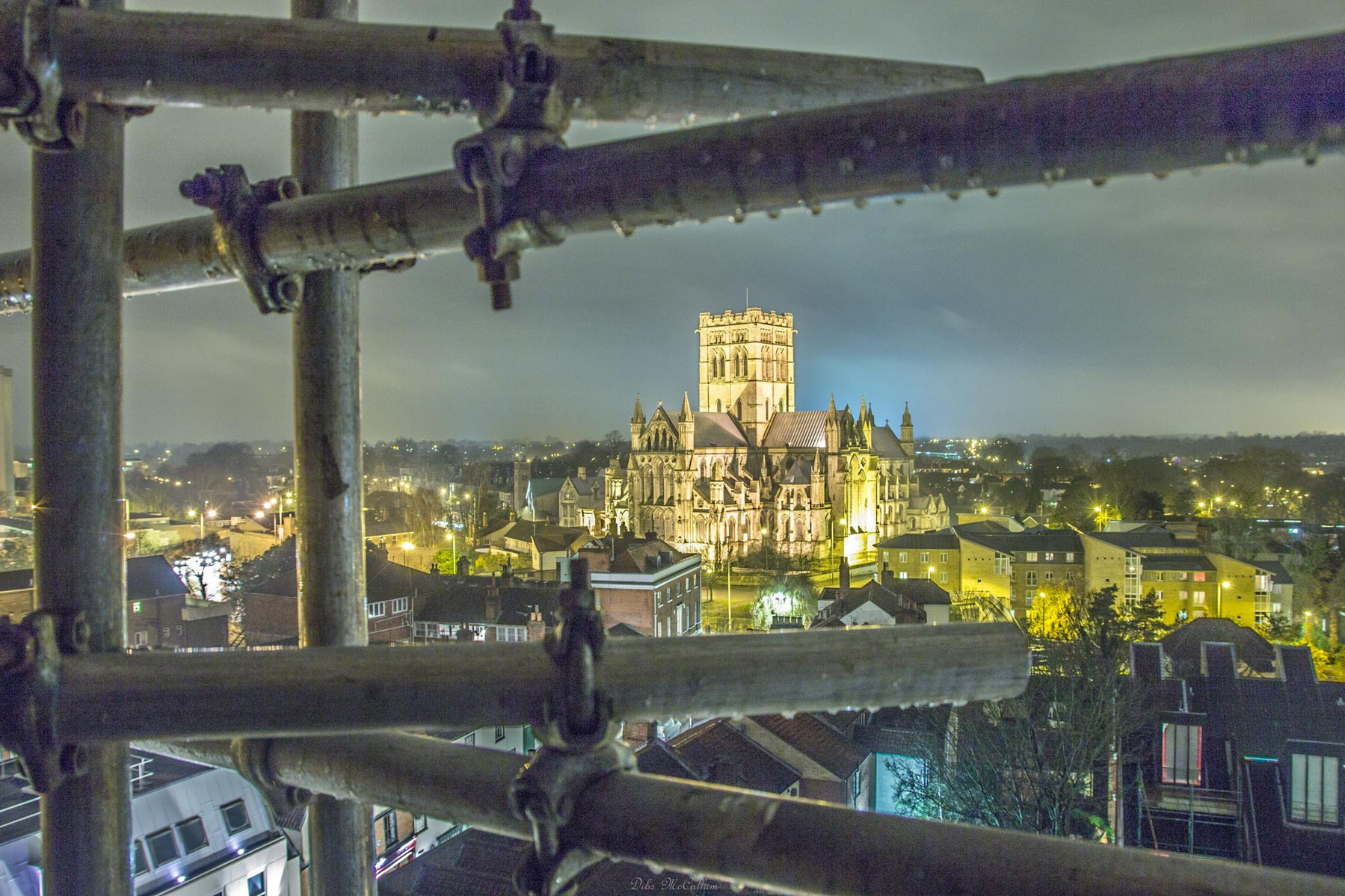St Johns roman catholic cathedral shot at night from St Giles on the hill church looking through the scaffolding bars used to climb up