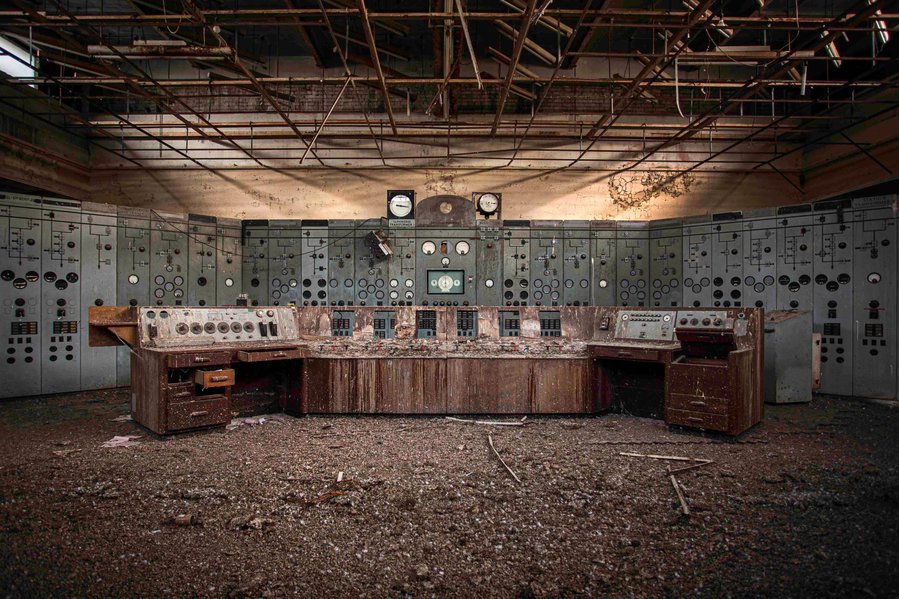 A derelict power station control panel has been left to decay but has now been demolished. It now just sits covered in pigeon mess and is illuminated by the early morning light creating a golden glow