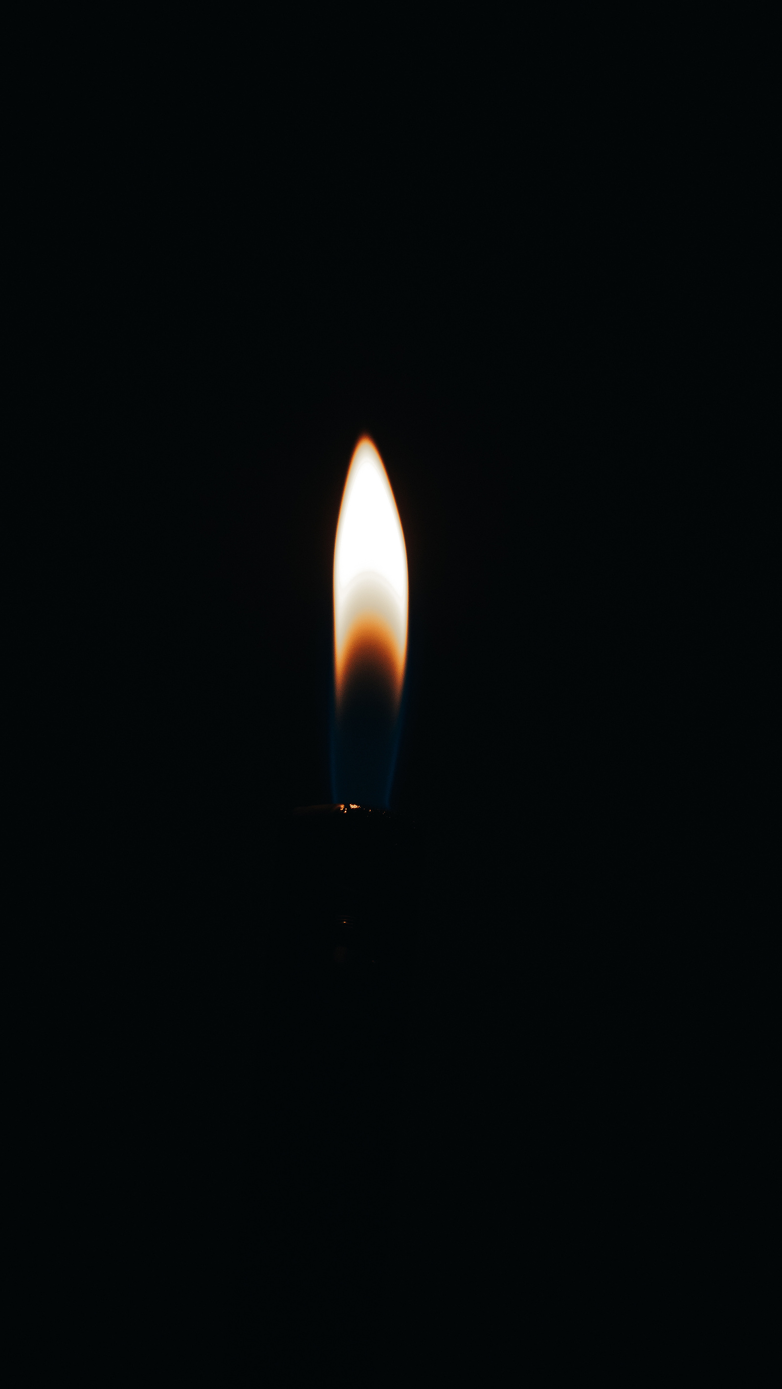 Flame from a lighter in the dark.