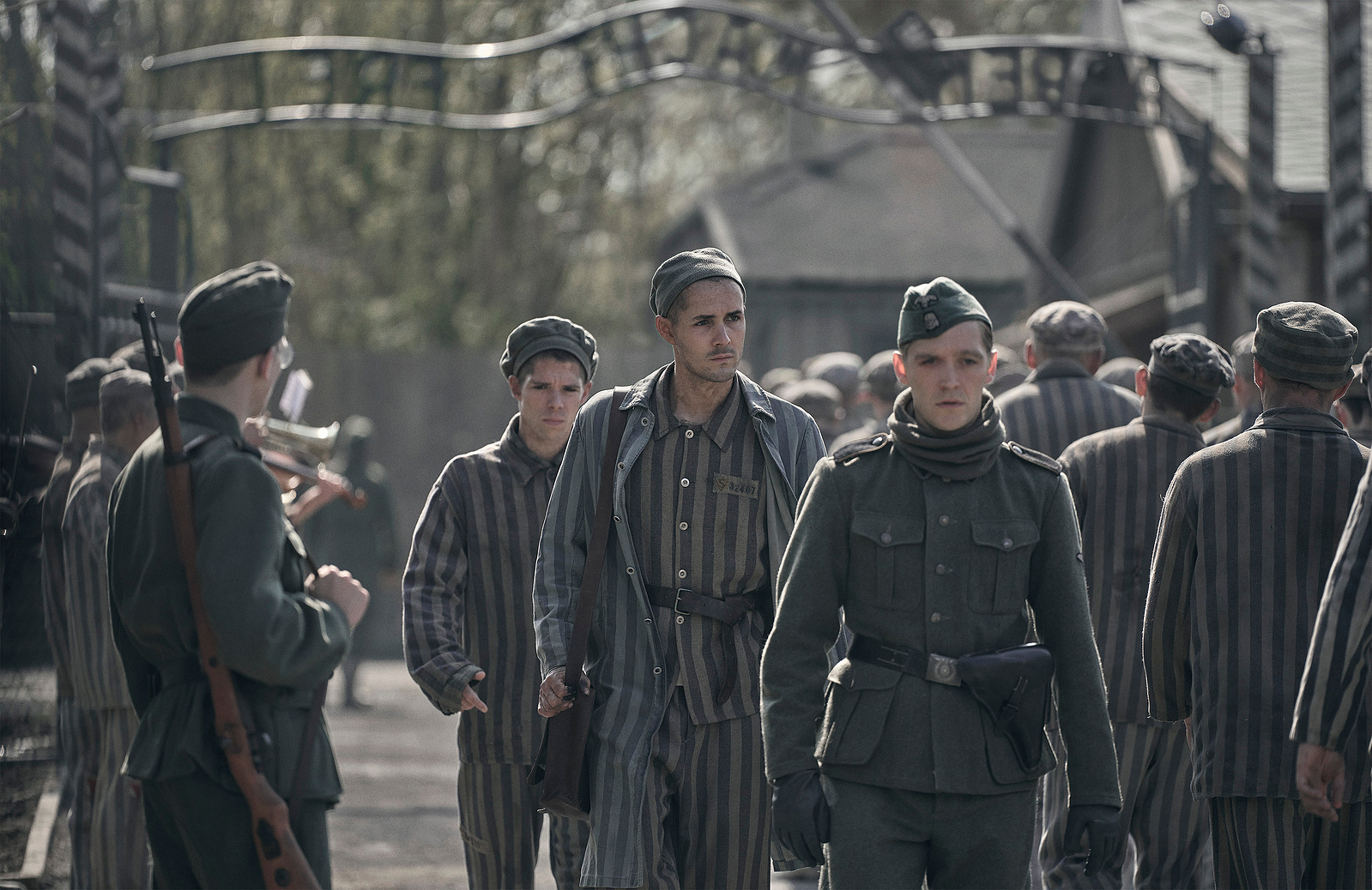 Jonah Hauer-King as Young Lale Sokolov and Jonas Nay as Stefan Baretzki in The Tattooist of Auschwitz (2024), Synchronicity Films, Peacock, SKY Studios