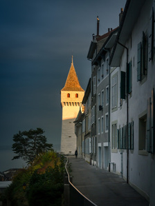 Light from a setting sun hits the top of a tower in Nyon, Switzerland.