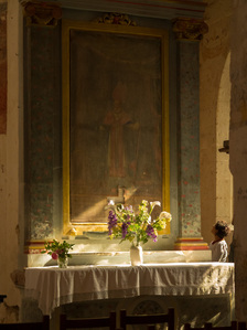 A sunlit alter in an old church in the Loire Valley, France.