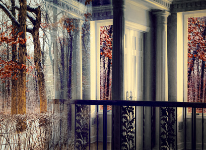 A composite image of an interior doorway superimposed on forest scene in winter.