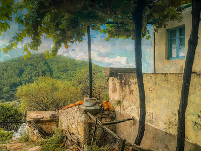 Photo-impressionist landscape with the wall of an old cottage with trees and a hilltop in the background.
