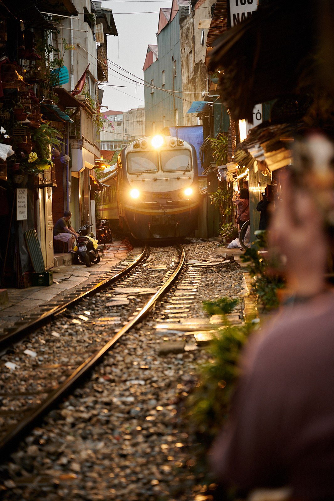 Amazingly these trains pass through a 'street' with cafe's and homes with less than a meter to spare on either side. A rainy evening produced a nice glow on the tracks in April 2022