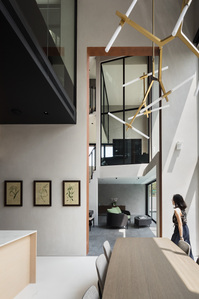 Double-storey height of dining area and stairwell of House 11 designed by Park + Associates.