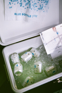 Cans of Blue Bottle Coffee in an icebox.