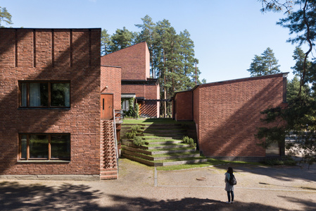 A girl staring up the terraced steps of Saynatsalo Town Hall designed by Alvar Aalto
