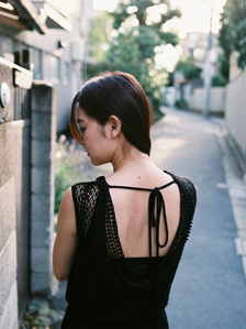 Portrait of a women's back looking pensive. The photograph is shot using analog film.