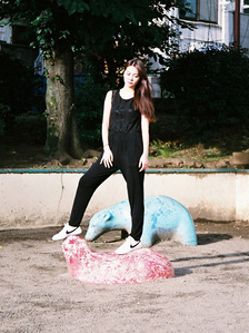 Portrait of a model wearing Nike shoes in the playground. The photograph is shot using analog film.