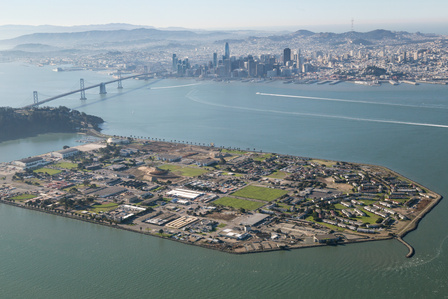 Helicopter aerial view of Treasure Island with San Francisco's skyline in the background.