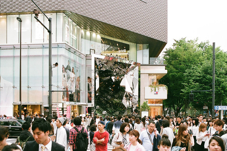 Pedestrian at traffic light crossing in front of Tokyu Plaza Omotesando Harajuku in Tokyo