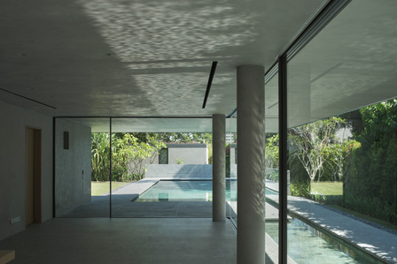 Reflection from the pool on the ceiling of the dining space of a house designed by Neri & Hu.