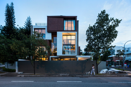 Facade of House 11 designed by Park + Associates photographed in the evening.