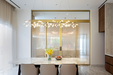 Dinning hall and the golden framed sliding door of the House of Light and Shadow designed by Yume Architects.