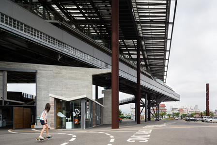 A girl rollerskating near the entrance to the Luodong Cultural Working House, designed by Fieldoffice Architects.