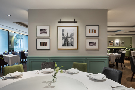 The interior of Thanying restaurant at the Amara Hotel Singapore designed by Knots with photos of Thailand hanging on the wall.