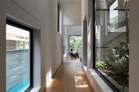 View of the corridor with windows on both sides in the Window House designed by Super Assembly.