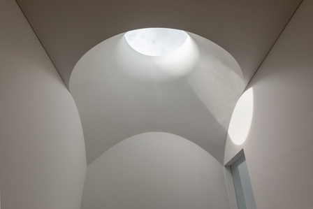 An oculus skylight, inspired by artist James Turrell at the stairwell of the House of Light and Shadow designed by Yume Architects.