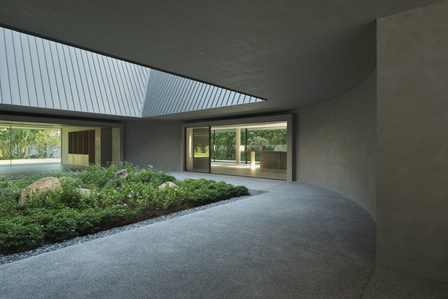 The curved wall of the courtyard of a house designed by Neri & Hu.