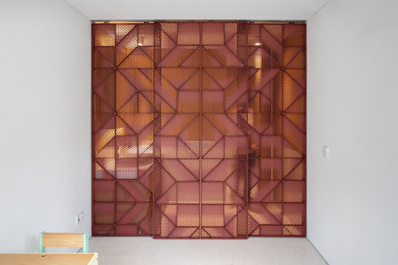 The metal door pattern on the powder room of the Window House designed by Super Assembly.