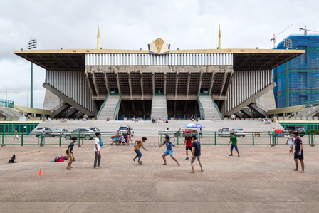 Kids in Phnom Penh, Cambodia, playing soccer in front of the Indoor Stadium of the National Sports Complex designed by Vann Molyvann.