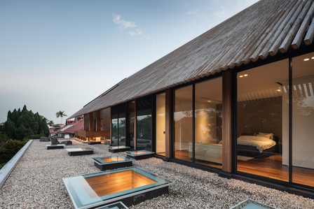 View of the second floor of the Aperture House designed by Formwerkz Architects with lights on.