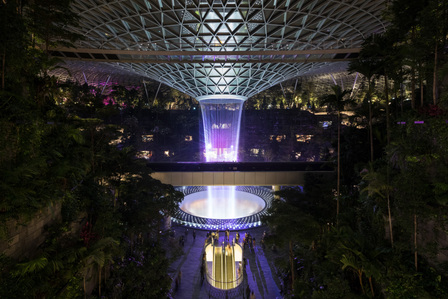 Midnight view of the Rain Vortex at Jewel Changi Airport with lighting designed by Lighting Planners Associates.