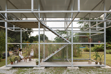 Two girls chatting leisurely inside the pavilion for Archifest 2020 at Gound-Up-Initiative designed by Spatial Anatomy.