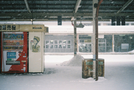 View of an empty snow-covered train station platform in winter in Hokkaido, Japan.