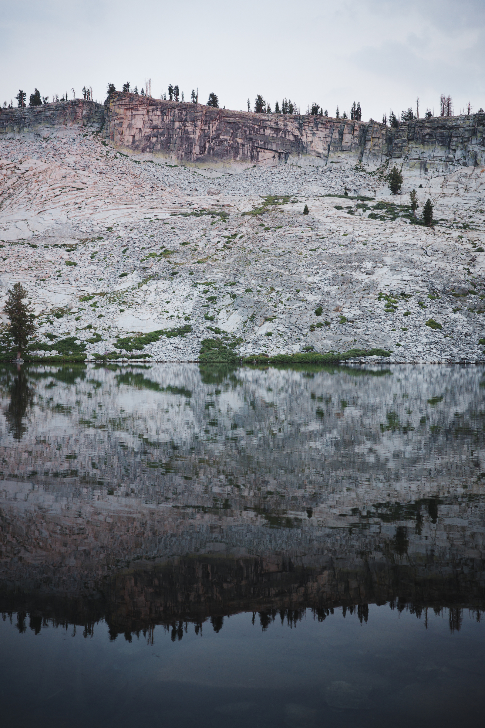 An evening shot, looking south at Ostrander Lake in Yosemite National Park, California, USA. Ricoh GR IIIx in Yosemite National Park. July 2024. Portrait of a landscape.