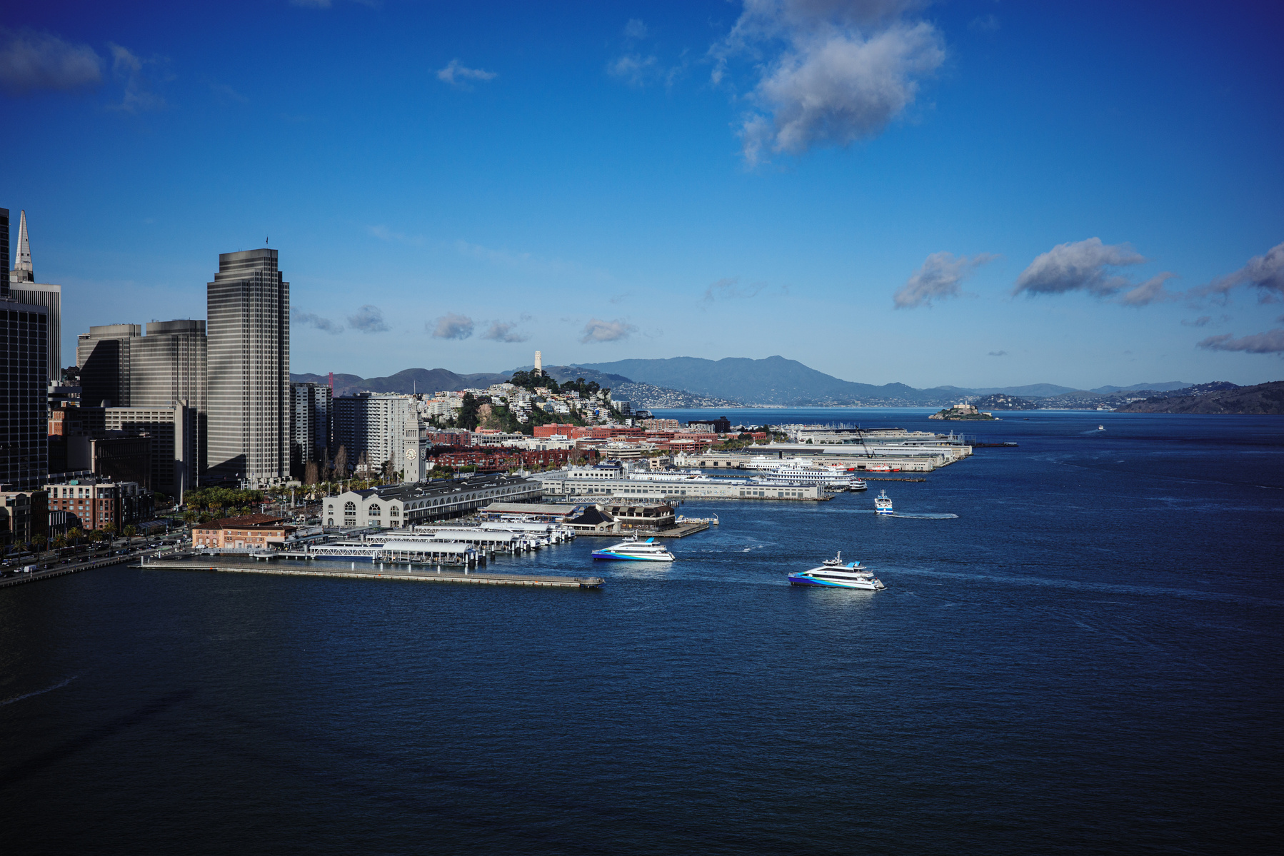 Explore the iconic San Francisco waterfront in this vibrant photo captured on a Ricoh GR camera. The image showcases the city’s stunning skyline, bustling piers, and scenic views of the Bay, including the famous Coit Tower and Alcatraz Island in the dista