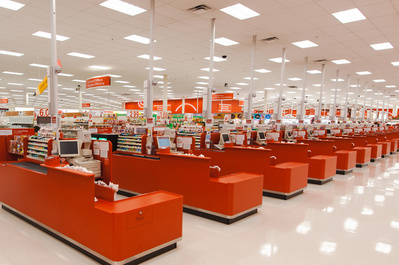 Abstract photo of several empty red checkout boxes without waiting lines in a gigantic supermarket.