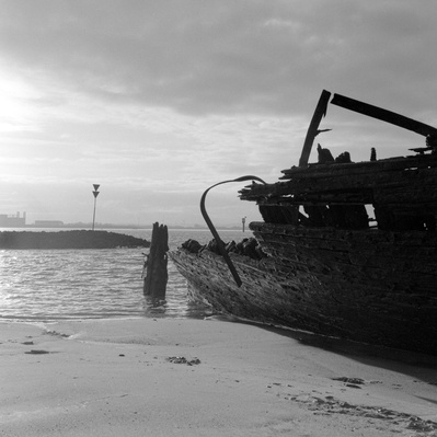 Black and white photo of an old ship wreck on the beach. Hasselblad 500CM, Kodak Tri-X 400.