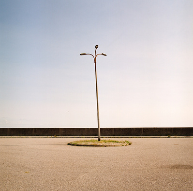 Triple lantern post looking like a palm tree made of metal. Shot on Hasselblad 500CM, Kodak Gold 200.