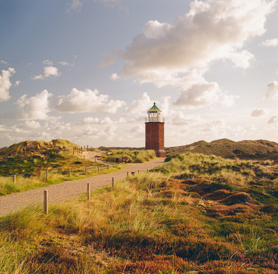 Lighthouse at the end of a pathway on the island of Sylt. Shot on analog medium format Hasselblad 500CM, Portra 400.