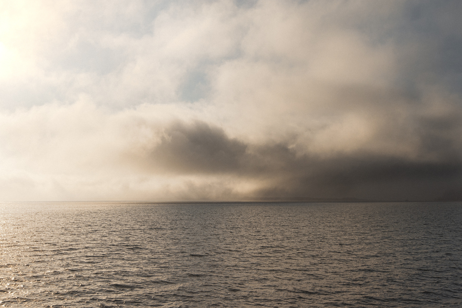 Fog falling into a lake.