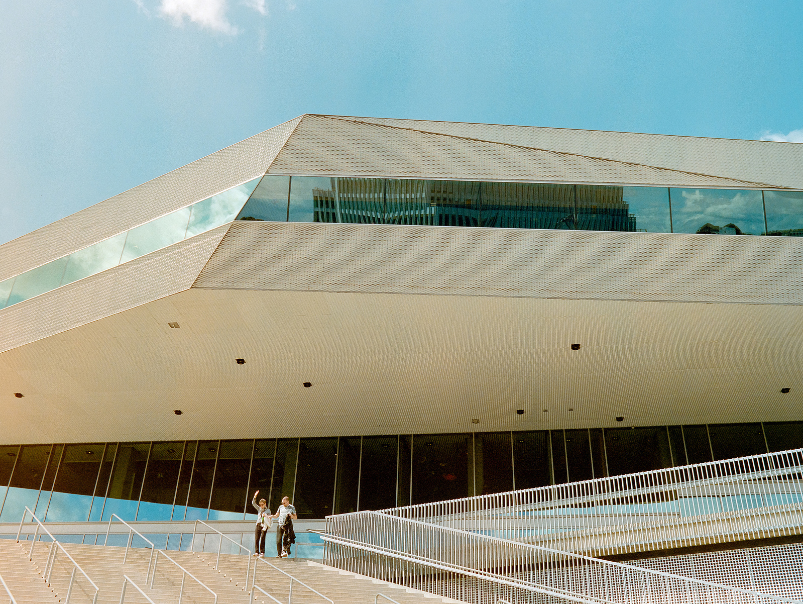 Couple waving hands in front of an impressive building in Aarhus, Denmark. 
Shot on Hasselblad 500CM, Portra 400.