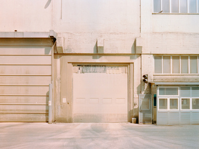 Empty white garage door of an industrial building in Aarhus, Denmark. Shot on Hasselblad 500CM, Kodak Gold 200.