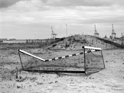 Abandoned broken football goal in the back of a port with cranes. Shot on Hasselblad 500CM, Ilford FP4.