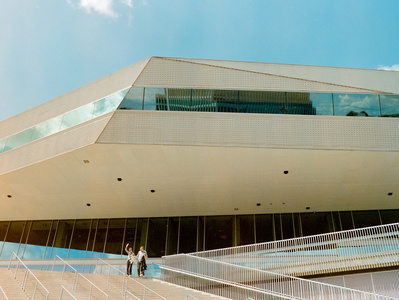 Couple waving hands in front of an impressive building in Aarhus, Denmark. 
Shot on Hasselblad 500CM, Portra 400.
